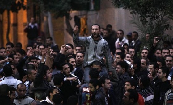 About 200 Coptic Christians, mostly youths, stage a noisy protest at dusk near the bombed church, before being dispersed by riot police firing tear gas in Alexandria, Egypt, on Sunday.
